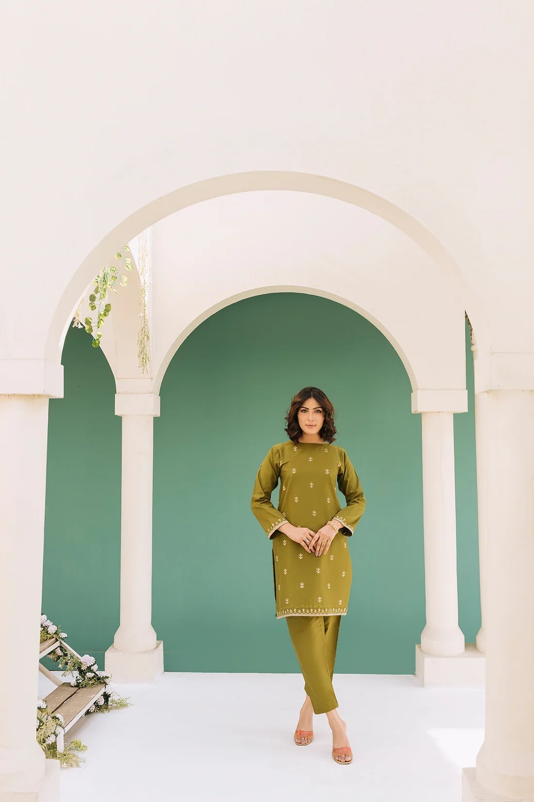 Pistachio and gold outfit framed by arches